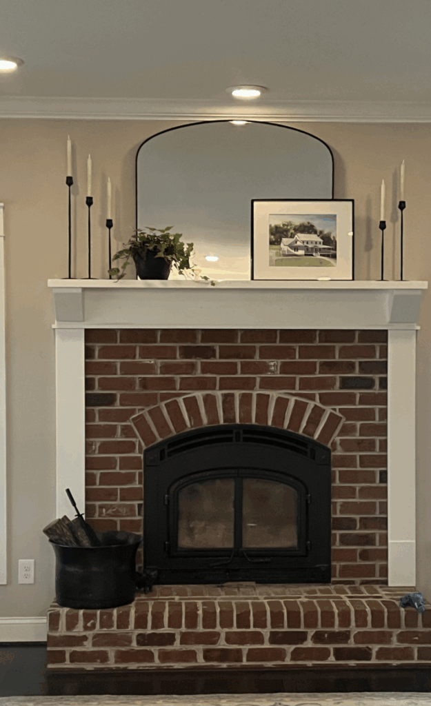 Canvas Interior room #3, Milholin mantel in living room with large mirror, candle sticks, and house picture.